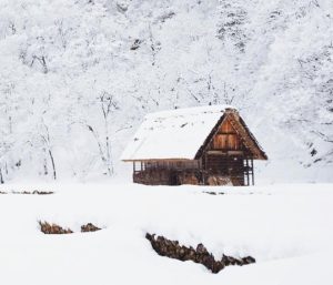 A wood cabin in a snowy landscape
