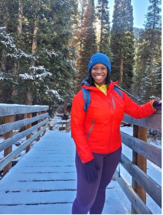 Nailah on a bridge all bundled up for winter
