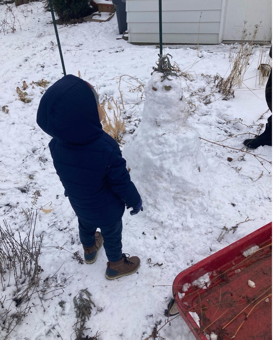 Caira's son Orion building a snow man