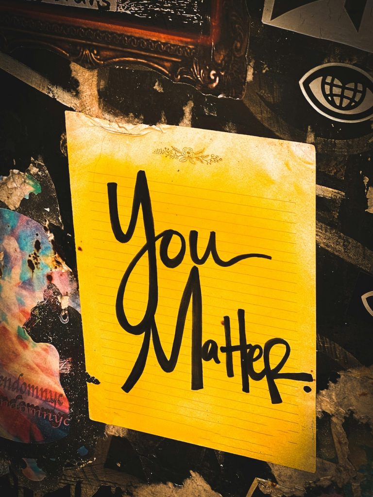 Yellow notebook page with "You Matter." written on it in black marker.