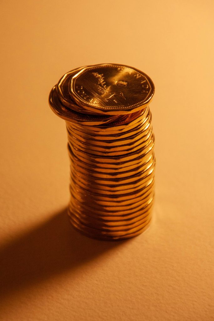 stack of coins on burnt orange background